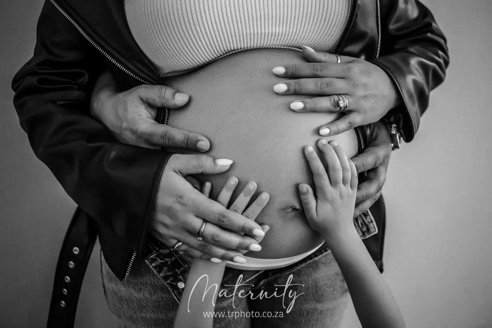 Hands resting on a pregnancy bump
