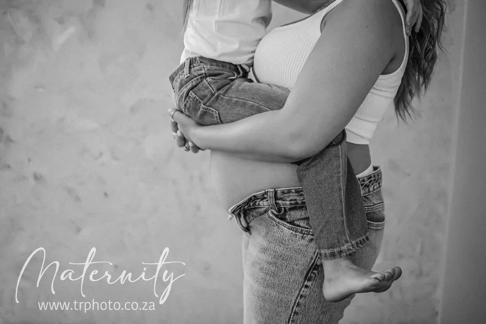 A toddler resting on her mum’s pregnancy bump
